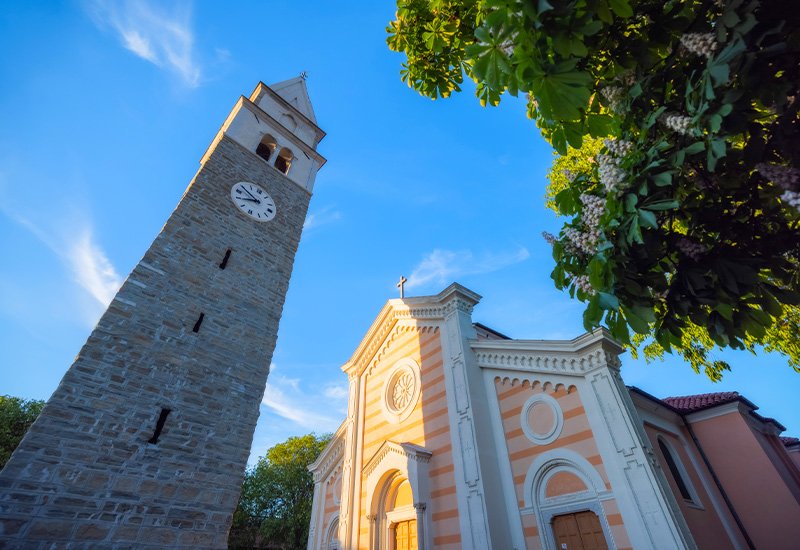 De kerk van Sint Maurus en de klokkentoren Izola Slovenië